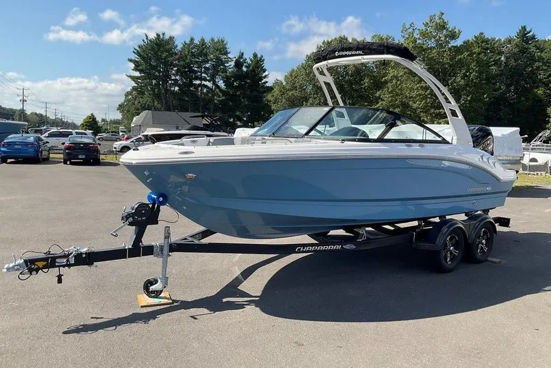 Slide: The Image of 2026 Chaparral 21 SSi OB boat on trailer, parked outdoors on a sunny day. - 30
