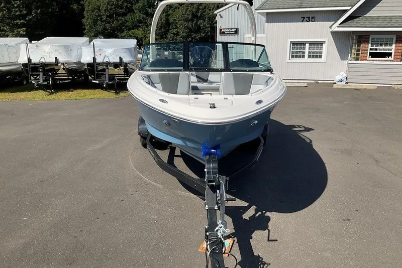 Slide: The Image of 2026 Chaparral 21 SSi OB boat on trailer, parked outside dealership. - 31