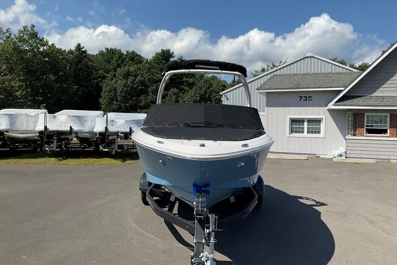Slide: The Image of 2026 Chaparral 21 SSi OB boat on trailer, parked outside a building. - 4