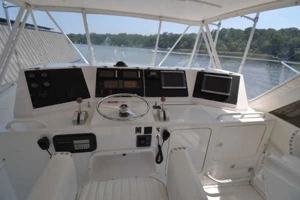 Slide: The Image of Helm of 1995 Bertram 50 Convertible yacht with navigation equipment and scenic water view. - 10