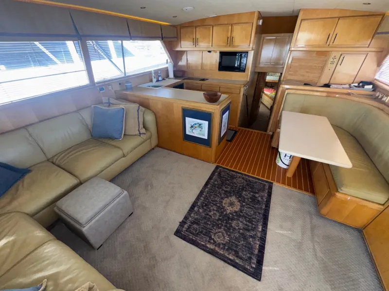 Slide: The Image of Interior of a 1995 Bertram 50 Convertible yacht with cozy seating and modern kitchen. - 16
