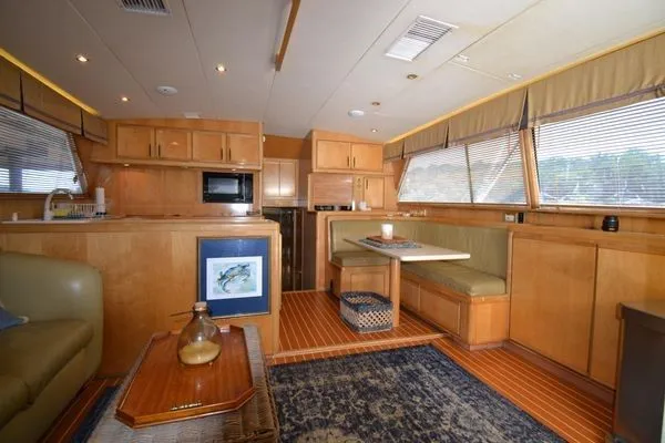 Slide: The Image of Interior of a 1995 Bertram 50 Convertible yacht with wood cabinetry and seating area. - 17