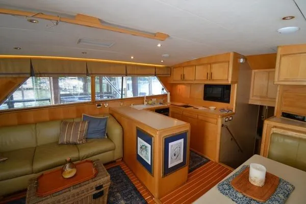Slide: The Image of Interior of a 1995 Bertram 50 Convertible yacht with modern kitchen and cozy seating area. - 18