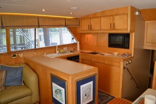 Slide: The Image of Interior of a 1995 Bertram 50 Convertible yacht with modern kitchen amenities. - 19
