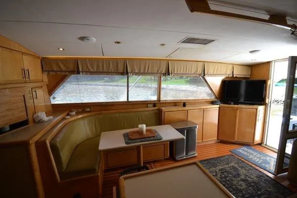 Slide: The Image of Interior of a 1995 Bertram 50 Convertible yacht with cozy seating and modern amenities. - 21