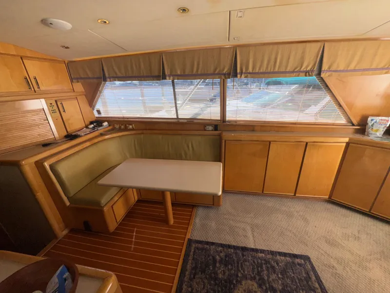 Slide: The Image of Interior of a 1995 Bertram 50 Convertible yacht with wood cabinetry and dining area. - 22