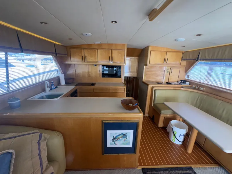 Slide: The Image of Interior of a 1995 Bertram 50 Convertible yacht with kitchen and dining area. - 23