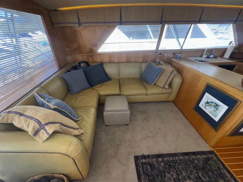Slide: The Image of Interior of 1995 Bertram 50 Convertible yacht with cozy seating and decor. - 24