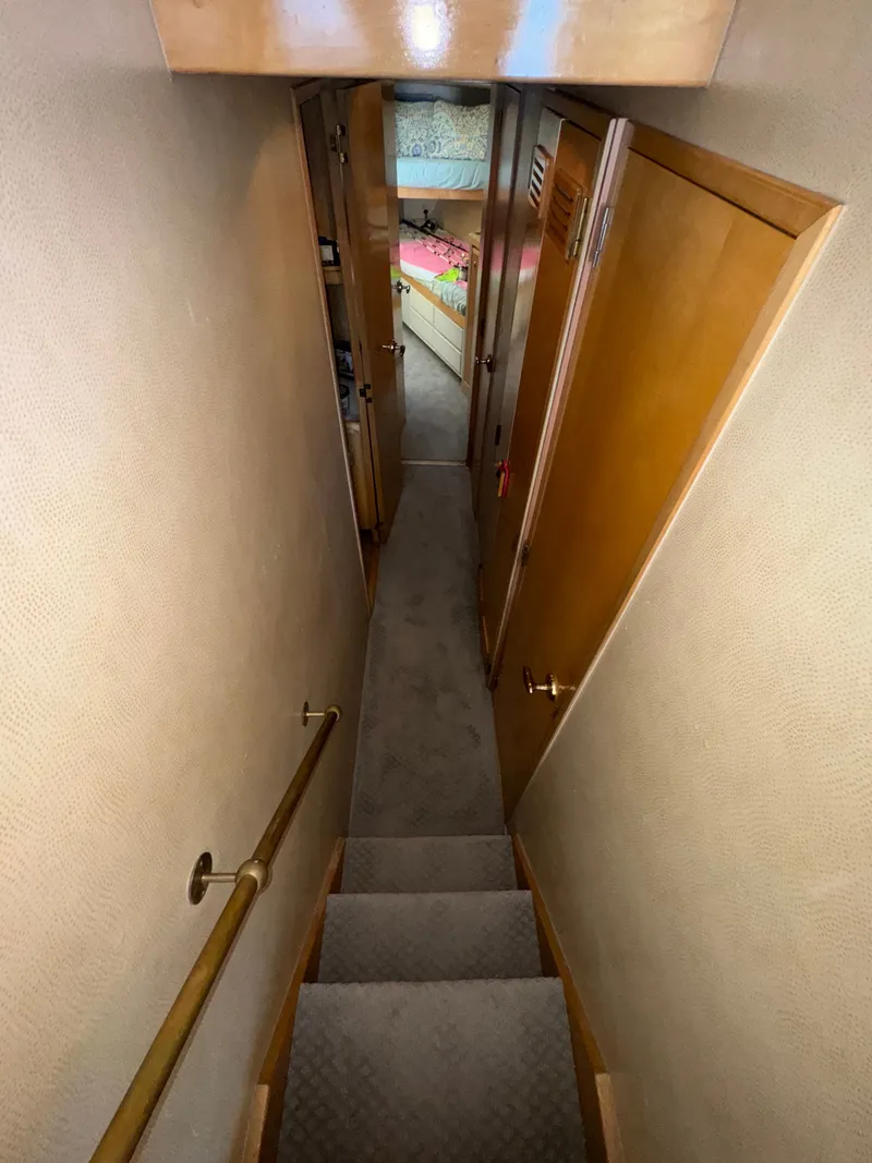 Slide: The Image of Narrow hallway with stairs inside a 1995 Bertram 50 Convertible yacht. - 26