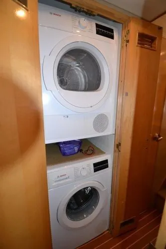 Slide: The Image of Stacked washer and dryer inside a 1995 Bertram 50 Convertible yacht. - 27