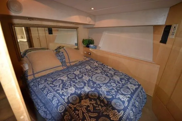 Slide: The Image of Cozy bedroom in 1995 Bertram 50 Convertible yacht with floral bedding and wood accents. - 29