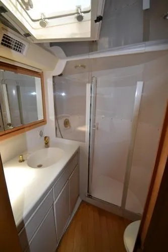 Slide: The Image of Bathroom interior of a 1995 Bertram 50 Convertible yacht with shower and vanity. - 32
