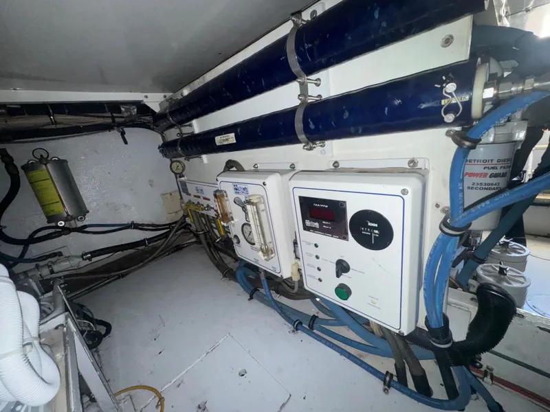 Slide: The Image of Engine room of a 1995 Bertram 50 Convertible with control panels and wiring. - 43