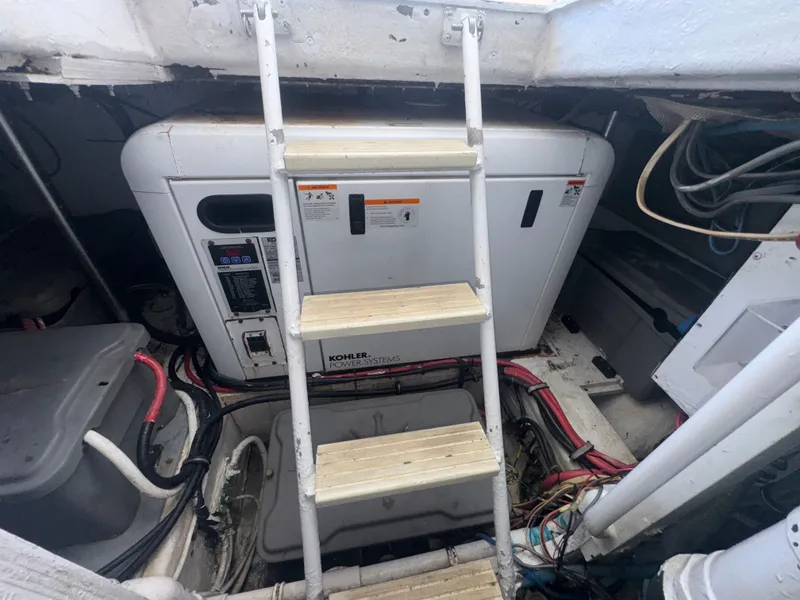 Slide: The Image of Engine room of a 1995 Bertram 50 Convertible with Kohler power system and ladder access. - 45