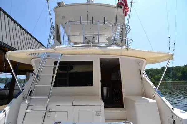 Slide: The Image of 1995 Bertram 50 Convertible yacht, rear view, docked with ladder and upper deck. - 6