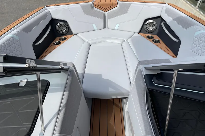 Slide: The Image of 2026 Nautique Super Air Nautique GS24 boat interior with luxurious seating and cup holders. - 11