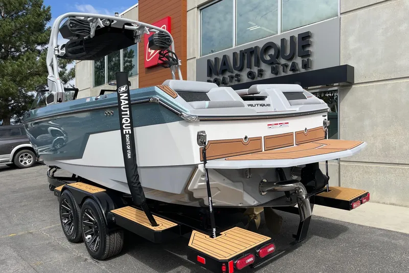 Slide: The Image of 2026 Nautique Super Air Nautique GS24 boat on trailer at dealership. - 3