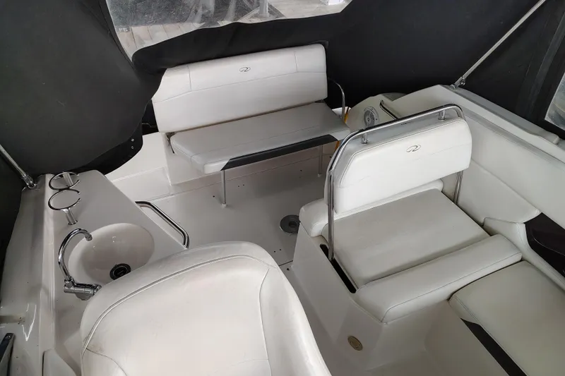 Slide: The Image of Interior of 2008 Regal 2565 Window Express boat with white seating and compact sink. - 12