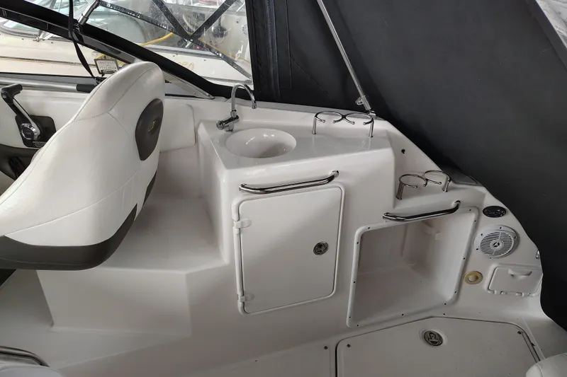 Slide: The Image of 2008 Regal 2565 Window Express boat interior with sink and seating area. - 14