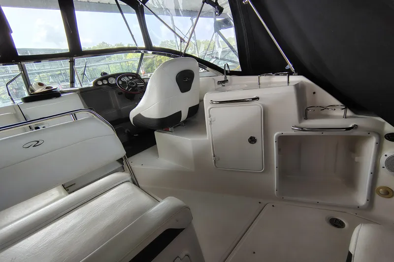 Slide: The Image of 2008 Regal 2565 Window Express boat interior with helm, seating, and storage compartments. - 15
