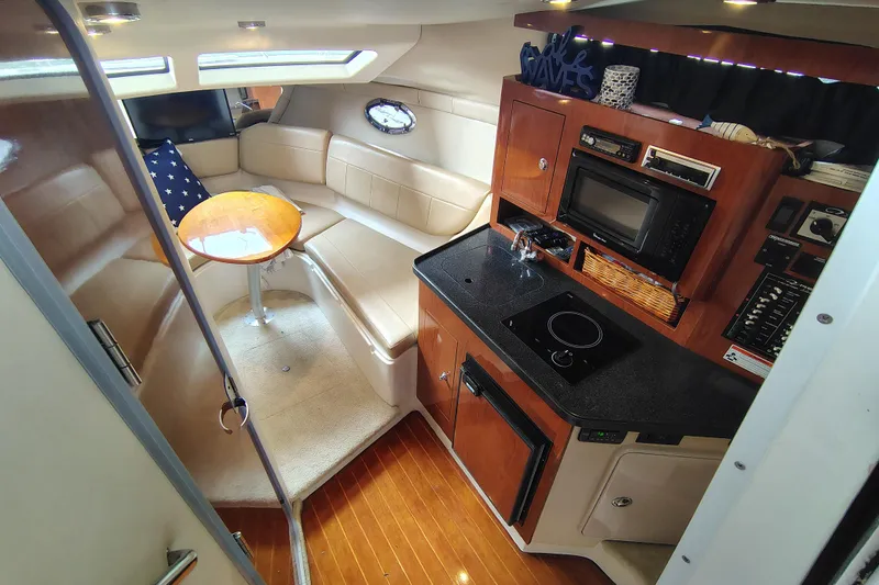 Slide: The Image of Interior of 2008 Regal 2565 Window Express boat with kitchenette and seating area. - 19