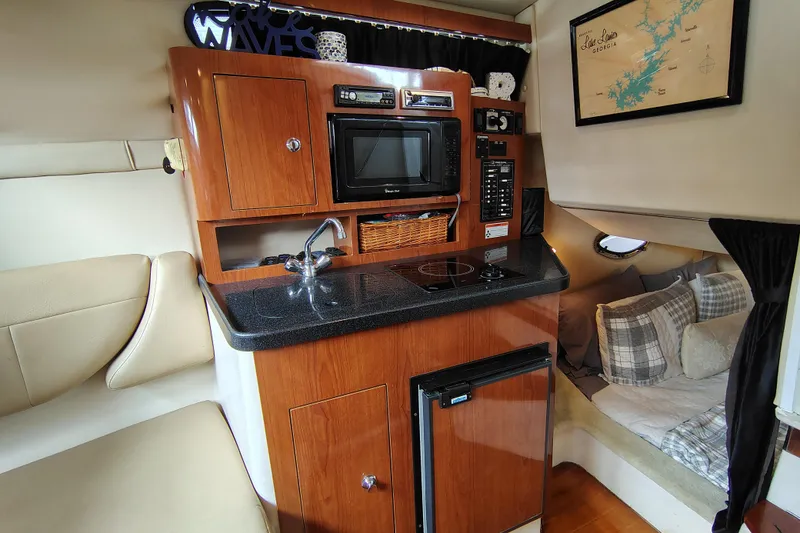 Slide: The Image of 2008 Regal 2565 Window Express cabin interior with kitchenette and cozy seating area. - 20