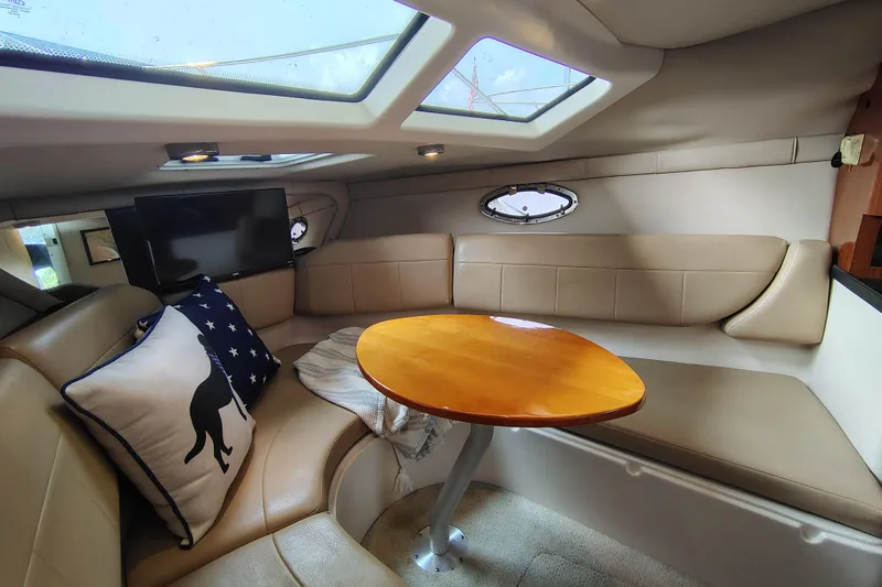 Slide: The Image of Interior of 2008 Regal 2565 Window Express boat with cozy seating and table. - 23