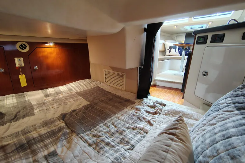 Slide: The Image of 2008 Regal 2565 Window Express cabin interior with cozy bedding and wooden accents. - 28