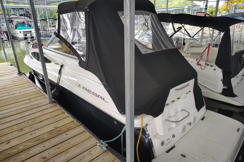 Slide: The Image of 2008 Regal 2565 Window Express boat docked with black canopy cover. - 3