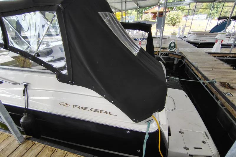 Slide: The Image of 2008 Regal 2565 Window Express boat docked with black cover in marina. - 6