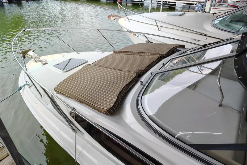 Slide: The Image of 2008 Regal 2565 Window Express boat with striped cushions docked at marina. - 7