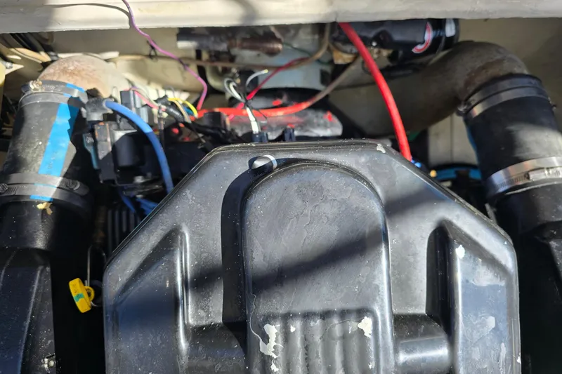 Slide: The Image of Engine compartment of a 1984 Bayliner 2802 Trophy boat, showing wiring and components. - 14