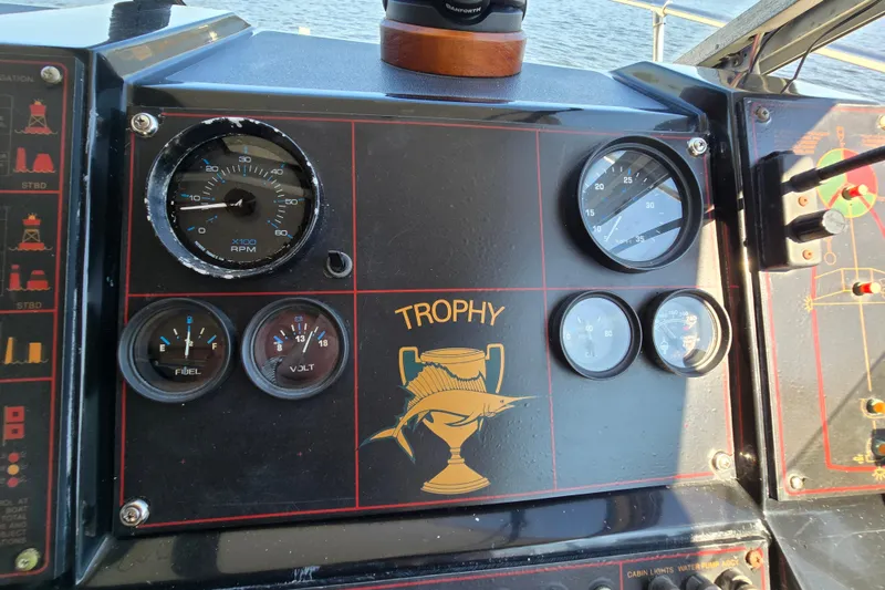 Slide: The Image of Dashboard of a 1984 Bayliner 2802 Trophy boat with gauges and Trophy logo. - 19