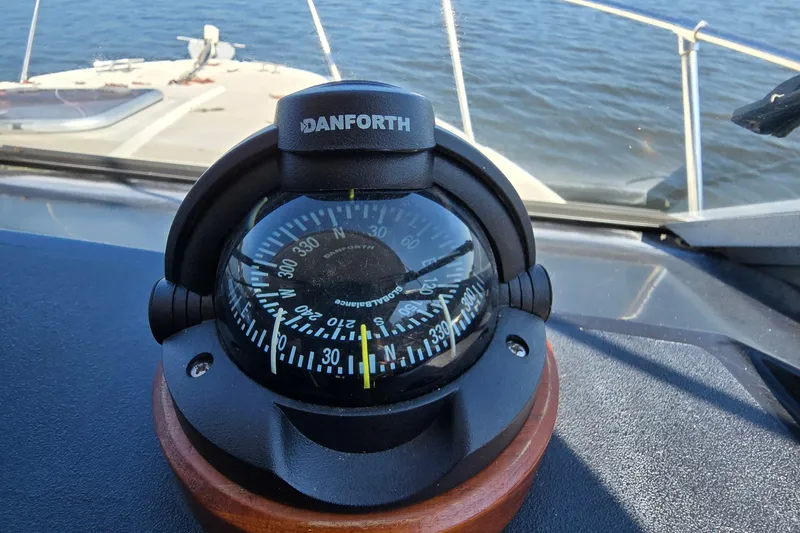Slide: The Image of Danforth compass on 1984 Bayliner 2802 Trophy boat, navigating calm waters. - 20