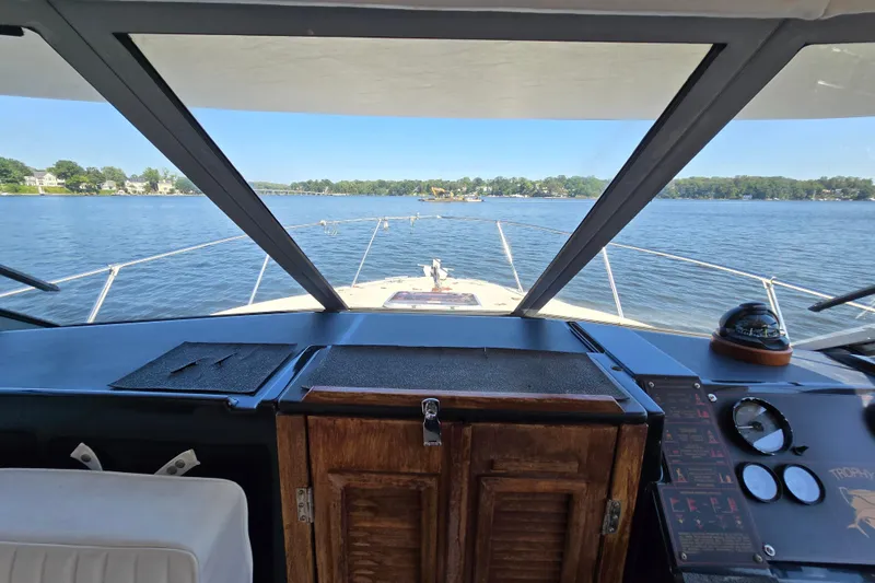 Slide: The Image of 1984 Bayliner 2802 Trophy boat cockpit with lake view and navigational instruments. - 21