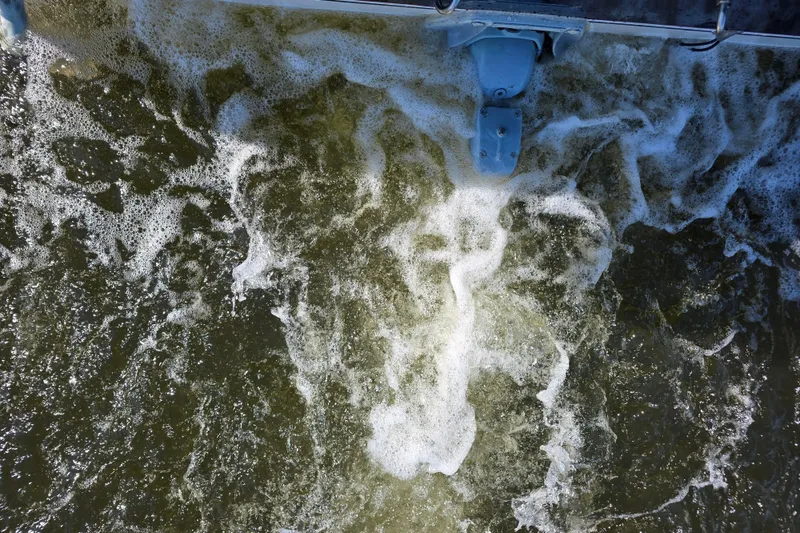 Slide: The Image of Wake turbulence behind 1984 Bayliner 2802 Trophy boat, churning water and foam visible. - 29