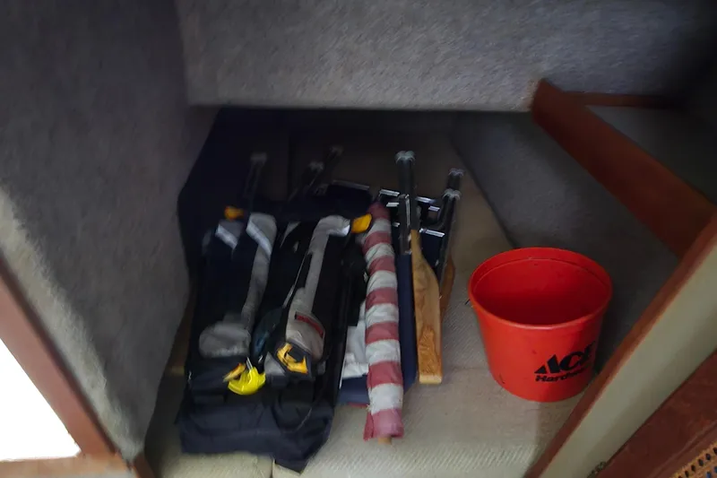 Slide: The Image of Storage area in 1984 Bayliner 2802 Trophy with tools and an orange bucket. - 35