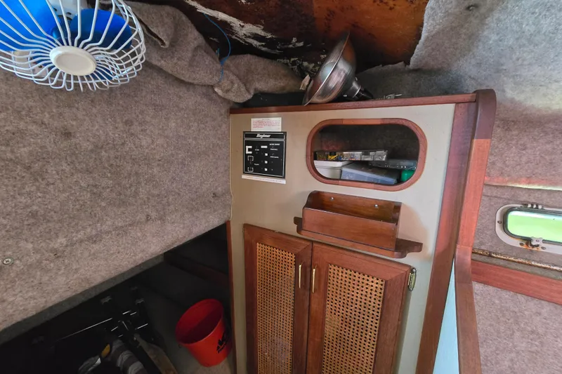 Slide: The Image of Interior of 1984 Bayliner 2802 Trophy boat with wooden cabinet and fan. - 36