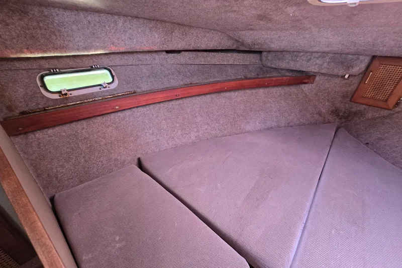 Slide: The Image of Interior cabin of 1984 Bayliner 2802 Trophy boat with cushioned seating and small window. - 39