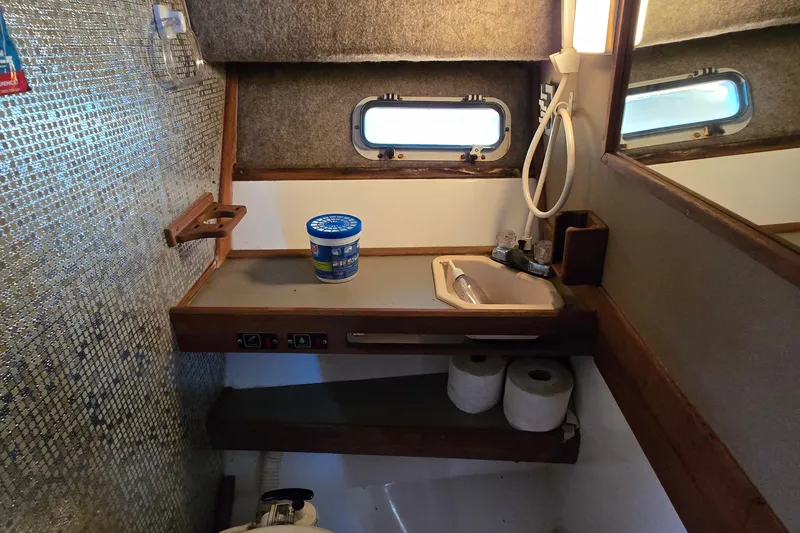 Slide: The Image of Interior of 1984 Bayliner 2802 Trophy boat bathroom with sink and storage shelves. - 41
