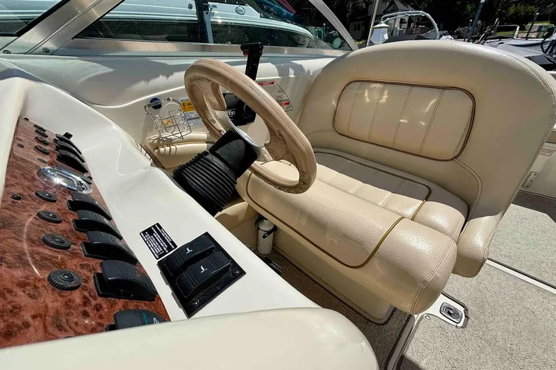 Slide: The Image of 1999 Sea Ray 260 Overnighter boat interior with steering wheel and control panel. - 10