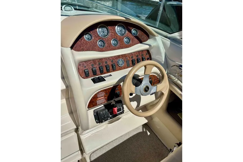 Slide: The Image of 1999 Sea Ray 260 Overnighter dashboard with gauges and steering wheel. - 11