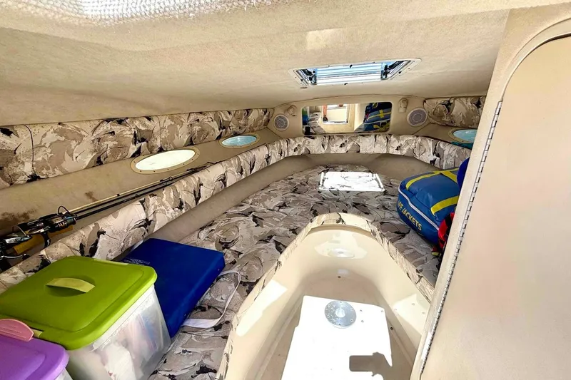 Slide: The Image of 1999 Sea Ray 260 Overnighter cabin interior with storage and seating. - 12