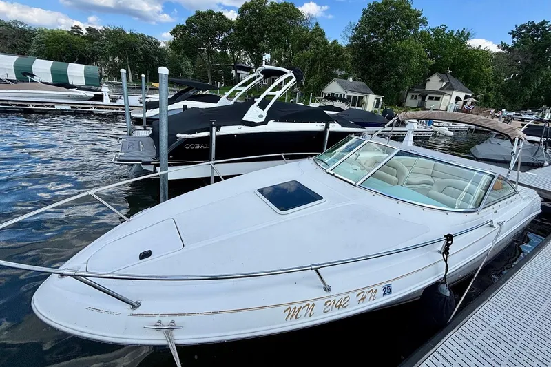 Slide: The Image of 1999 Sea Ray 260 Overnighter docked at a marina with other boats. - 3