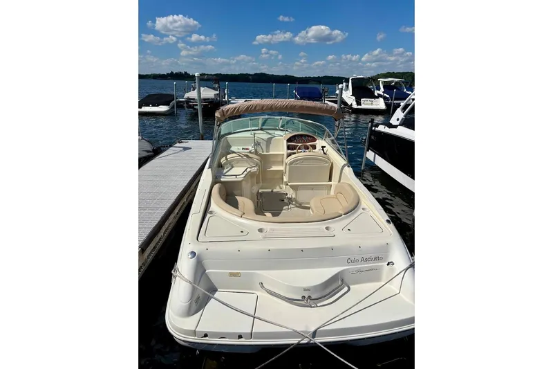 Slide: The Image of 1999 Sea Ray 260 Overnighter boat docked on a sunny day with clear skies. - 4