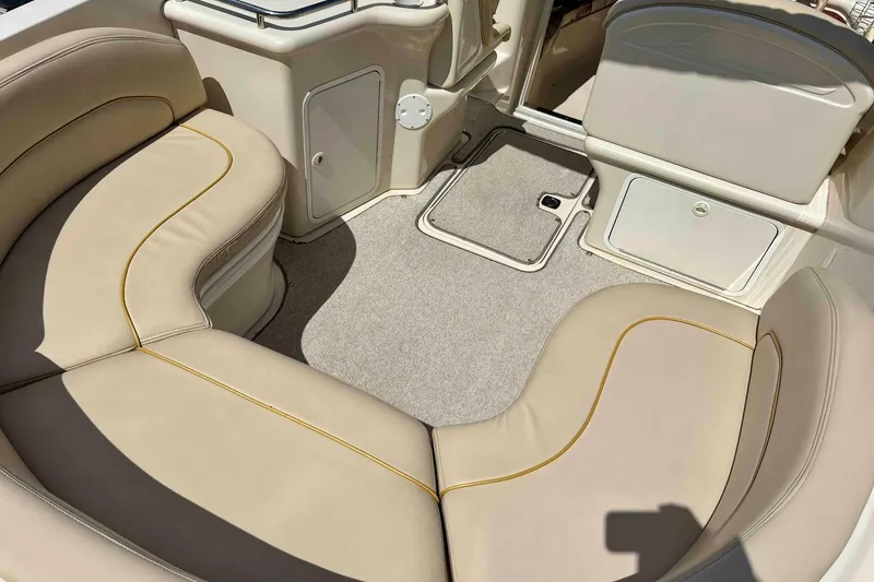 Slide: The Image of 1999 Sea Ray 260 Overnighter boat interior with beige seating and carpeted floor. - 6