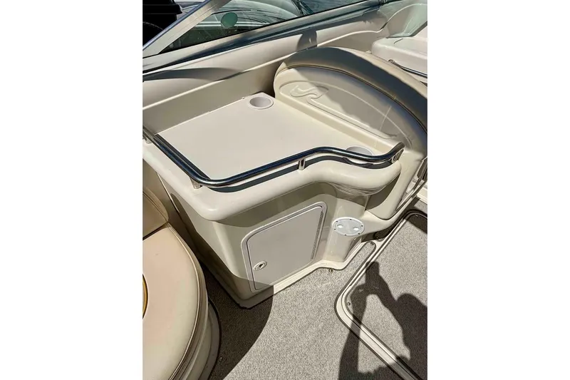 Slide: The Image of 1999 Sea Ray 260 Overnighter interior with seating and storage area. - 7