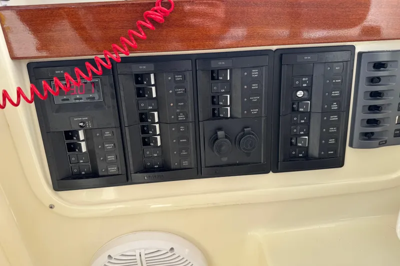 Slide: The Image of Electrical control panel on 2026 NorthCoast 285 HT boat, featuring various switches and outlets. - 27