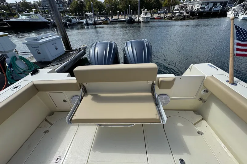 Slide: The Image of 2026 NorthCoast 285 HT boat with dual engines, docked at a marina. - 3