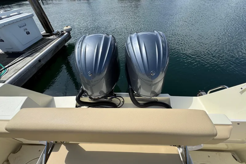 Slide: The Image of Twin outboard motors on a 2026 NorthCoast 285 HT boat at a dock. - 4